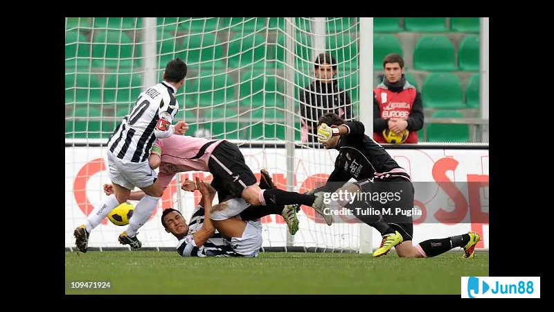 A Udinese player dribbles past a Palermo defender in a heated match